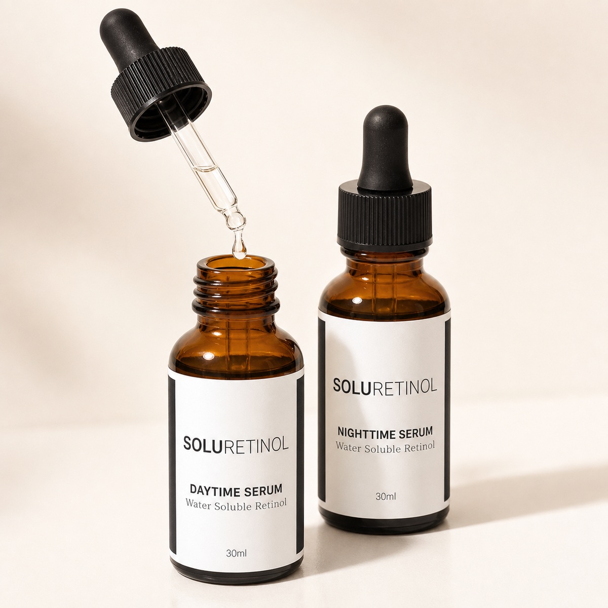 Dropper lifted with a single drop falling into the Daytime Serum bottle